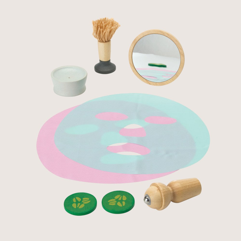 PlanToys spa set components including facial roller brush cucumber slices and candle