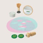 PlanToys spa set components including facial roller brush cucumber slices and candle