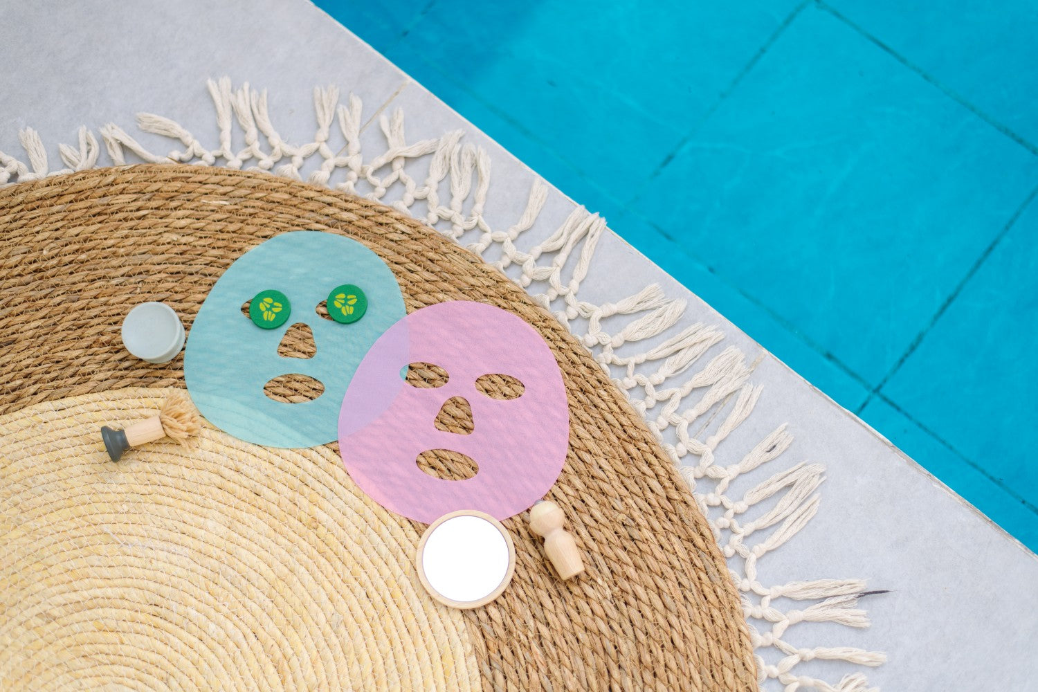 Two colorful face masks on a textured mat with a blue and gray background