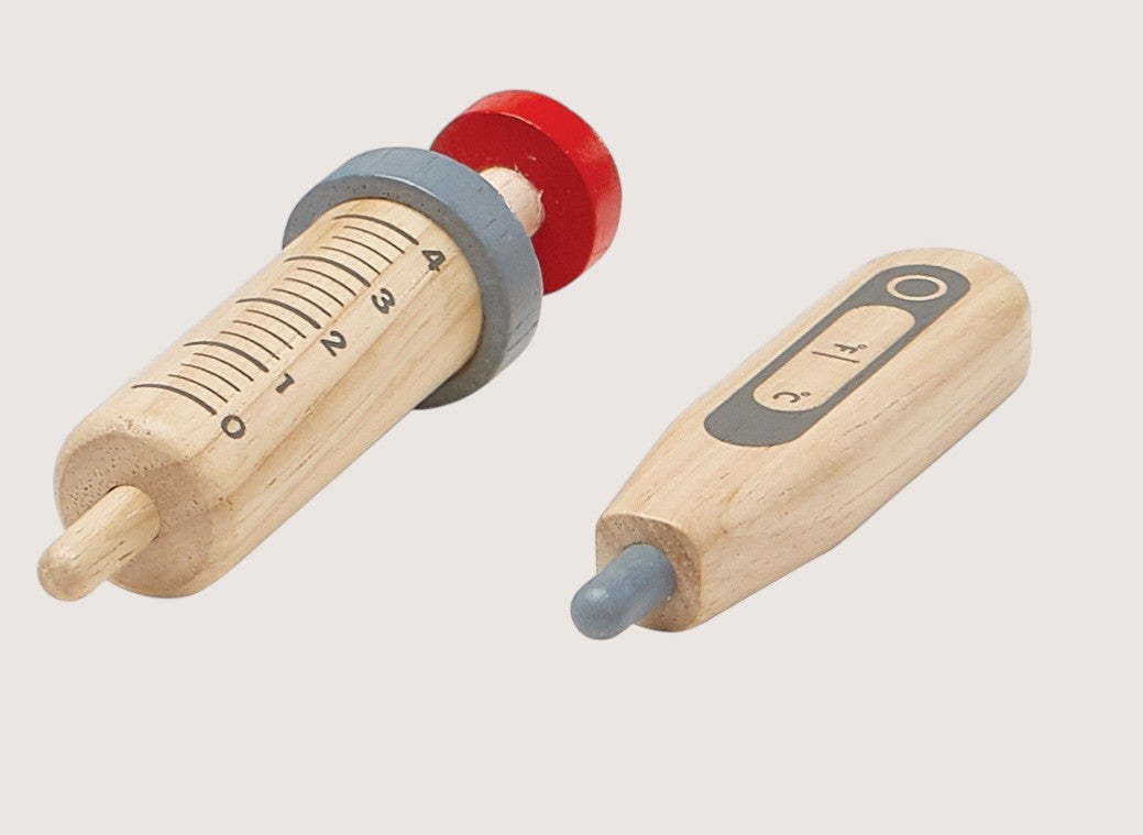 Two wooden rolling pins with measurement markings on a light gray background