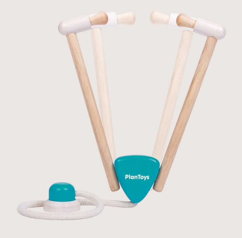 Wooden toy with a blue handle and white rope on a light gray background, featuring the PlanToys logo.