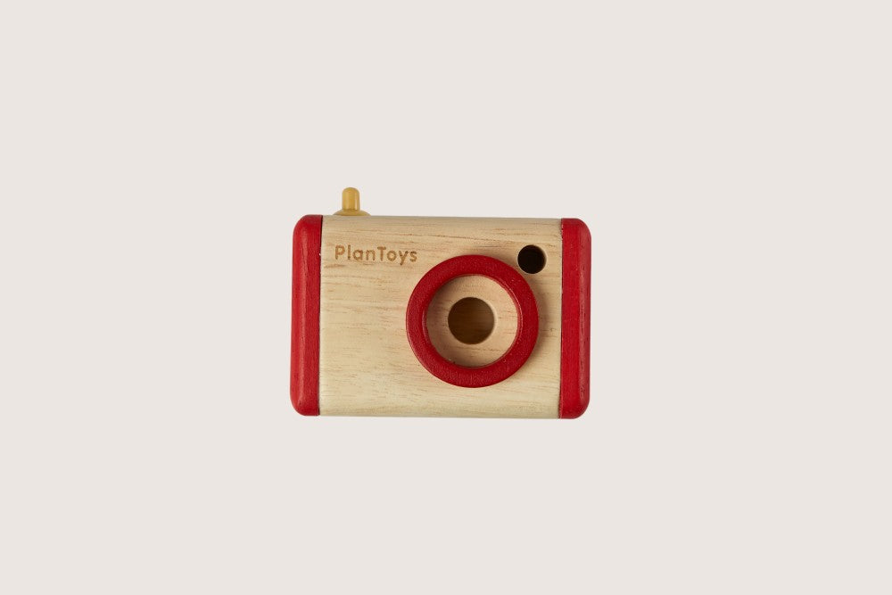 Close-up of PlanToys sustainable wooden camera and rubber ring light