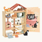 Wooden cat toy house with small cat figures and a 'Cat Files' book on a white background