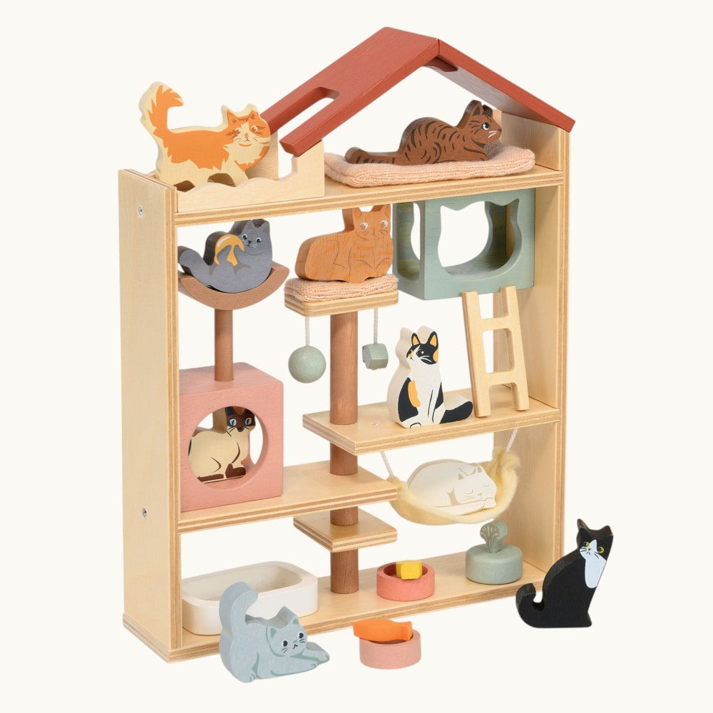 Wooden pet playhouse with shelves and cat-shaped toys on a white background