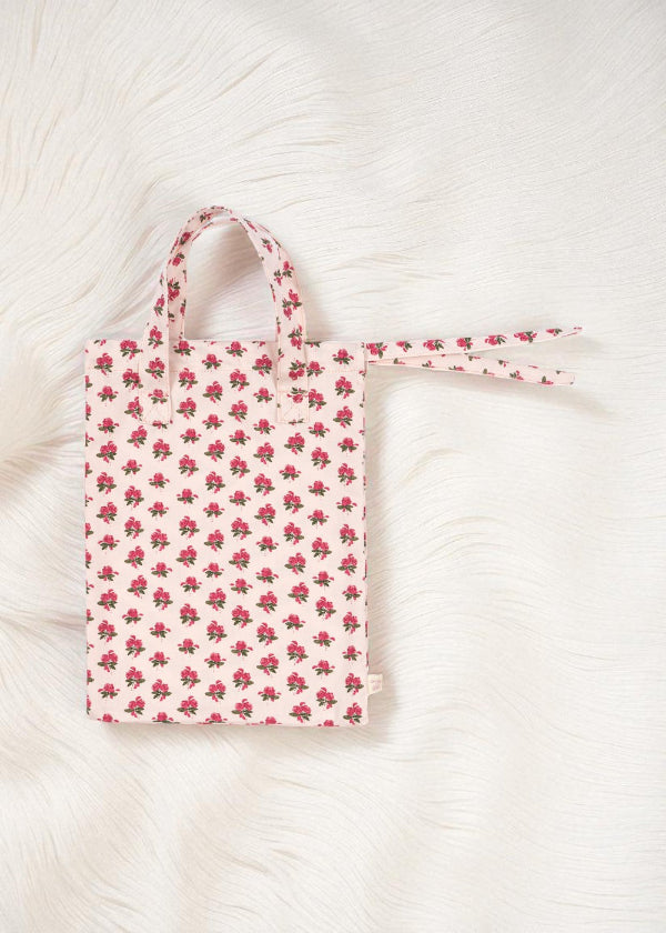 Floral-patterned tote bag on a textured white surface