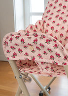 Close-up of quilted rose print cushion showing delicate pink roses with green leaves pattern and premium cotton construction