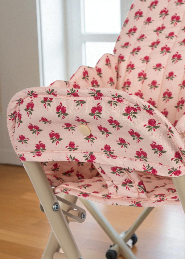 Close-up of quilted rose print cushion showing delicate pink roses with green leaves pattern and premium cotton construction