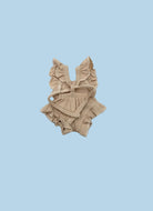 A beige ribbed knit baby romper with ruffled shoulder straps, a tie detail at the chest, and ruffled trim along the neckline and bottom, laid flat on a white background.