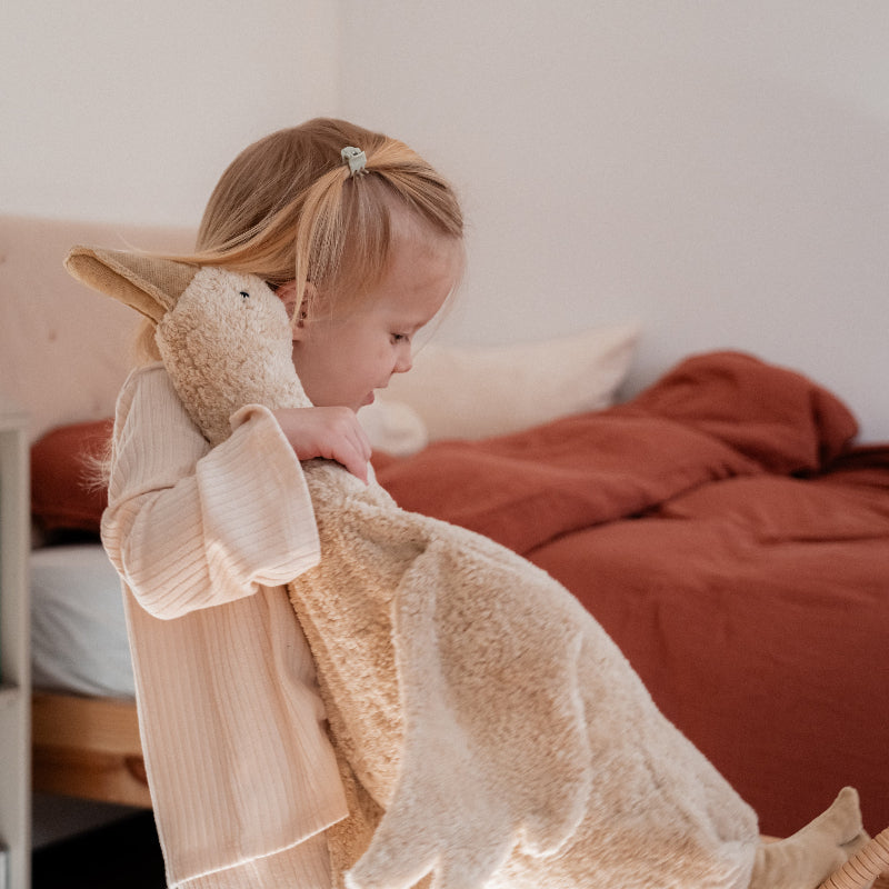 Handcrafted organic cotton goose stuffed animal shown flat with removable warming pillow