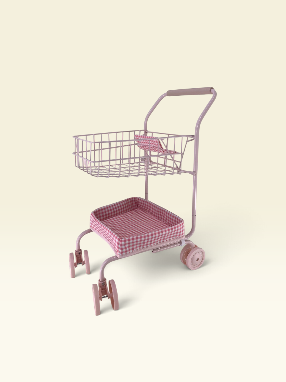 A pink metal shopping cart with a wire basket on top and a cushioned seat, shown on a plain cream background.