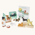 Wooden toy set with dogs and a vet, including a display stand with 'Waggy Tales' branding.