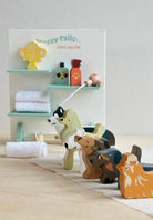 Wooden dog toys with a 'Waggy Tails Dog Salon' sign in the background.