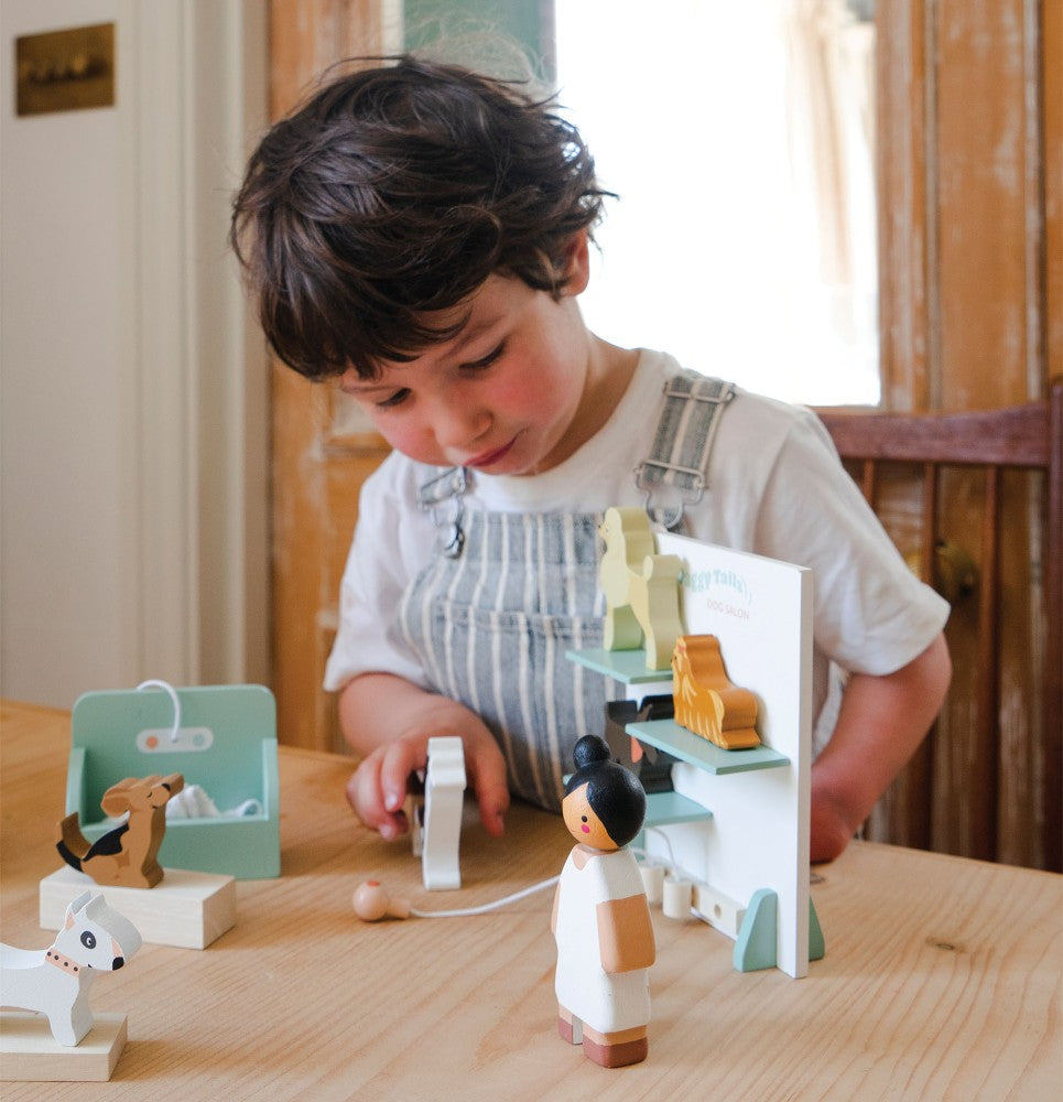 Child playing with wooden toys on a table