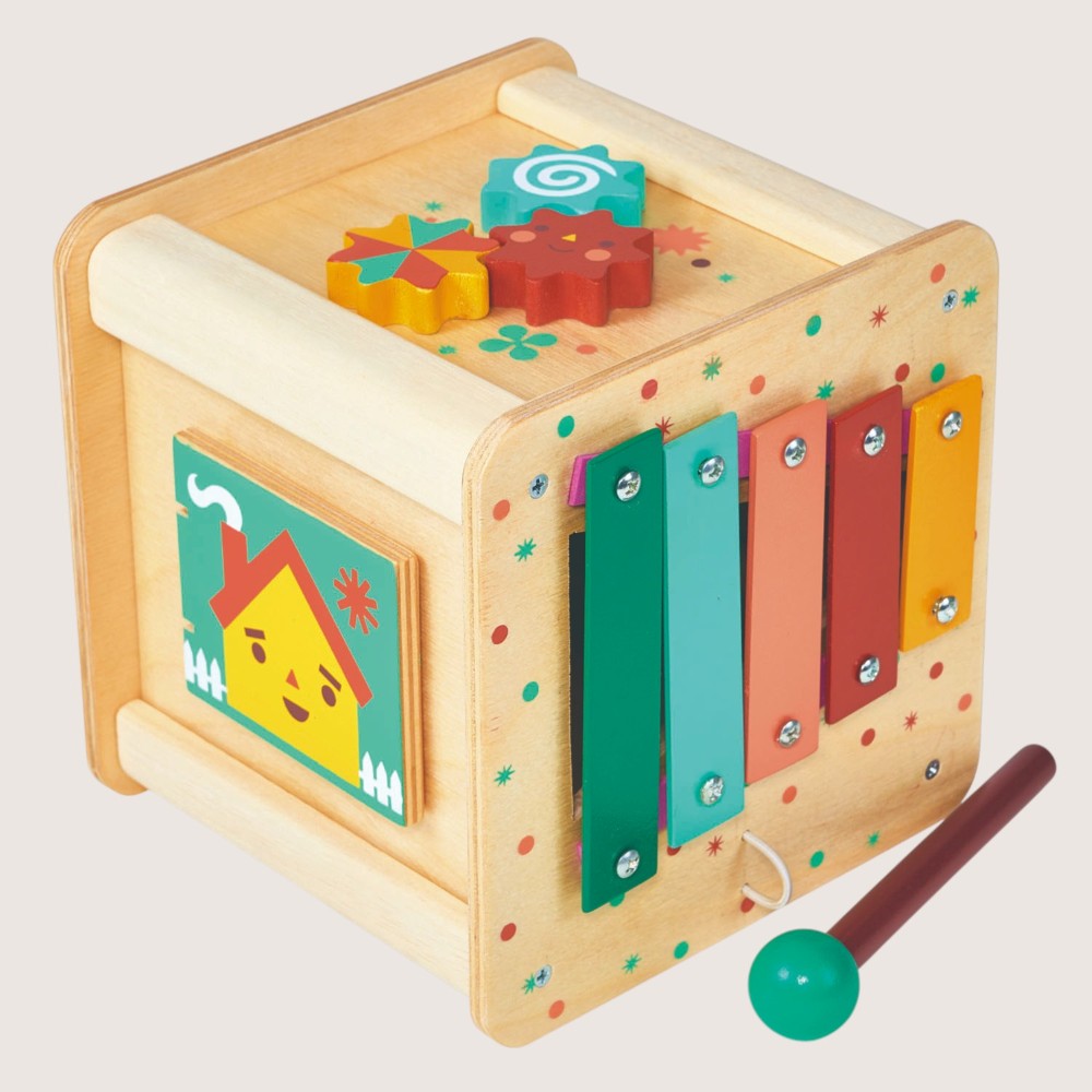 Wooden children's toy with colorful panels and a mallet on a light gray background