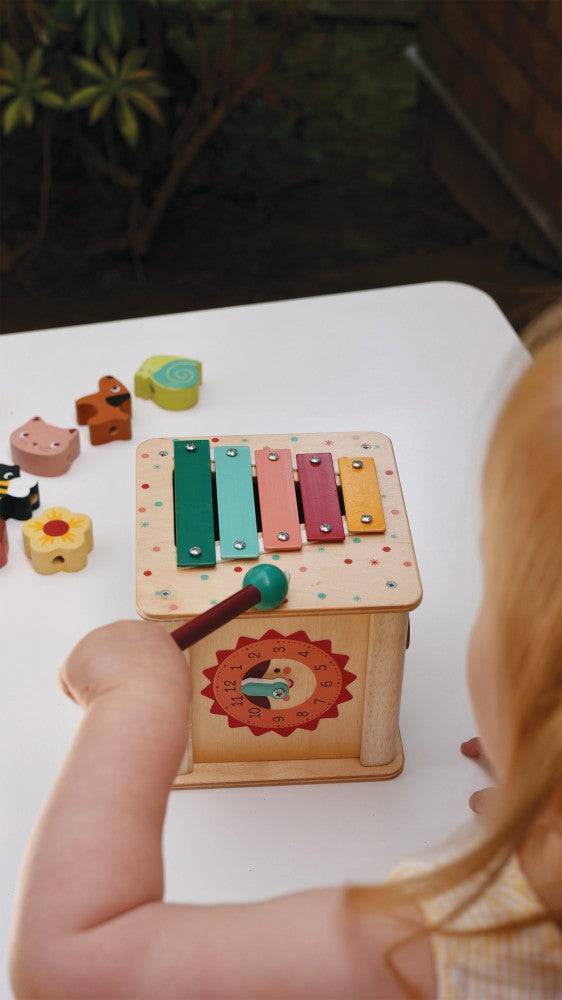 Child playing with Mentari multi-activity cube exploring different learning sides