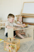 Two Children Reading on Lap Desk