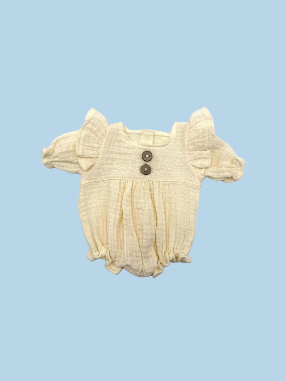 Cotton muslin one-piece romper with vintage button detail and easy velcro back closure