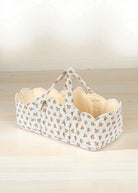 Verona Blues doll bassinet with Italian-inspired floral print, blue bouquets and cream quilted interior lining