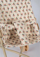 Close-up of vintage botanical print fabric with safety harness on collapsible doll pushchair