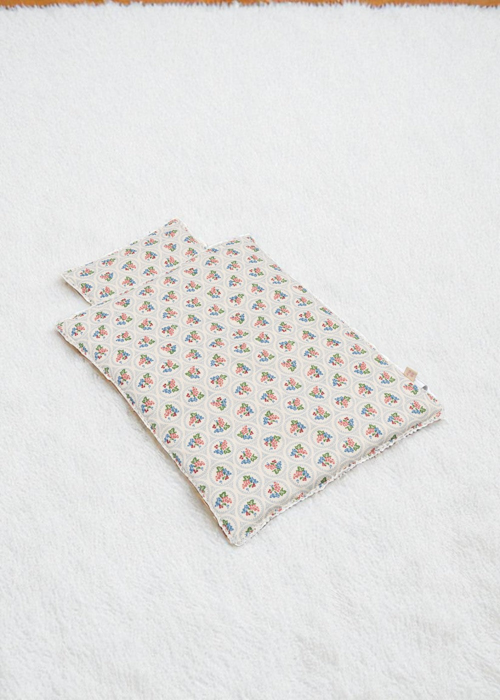 Verona Blues bedding set with Italian-inspired floral print blanket and pillow arranged together showing coordinated Mediterranean design