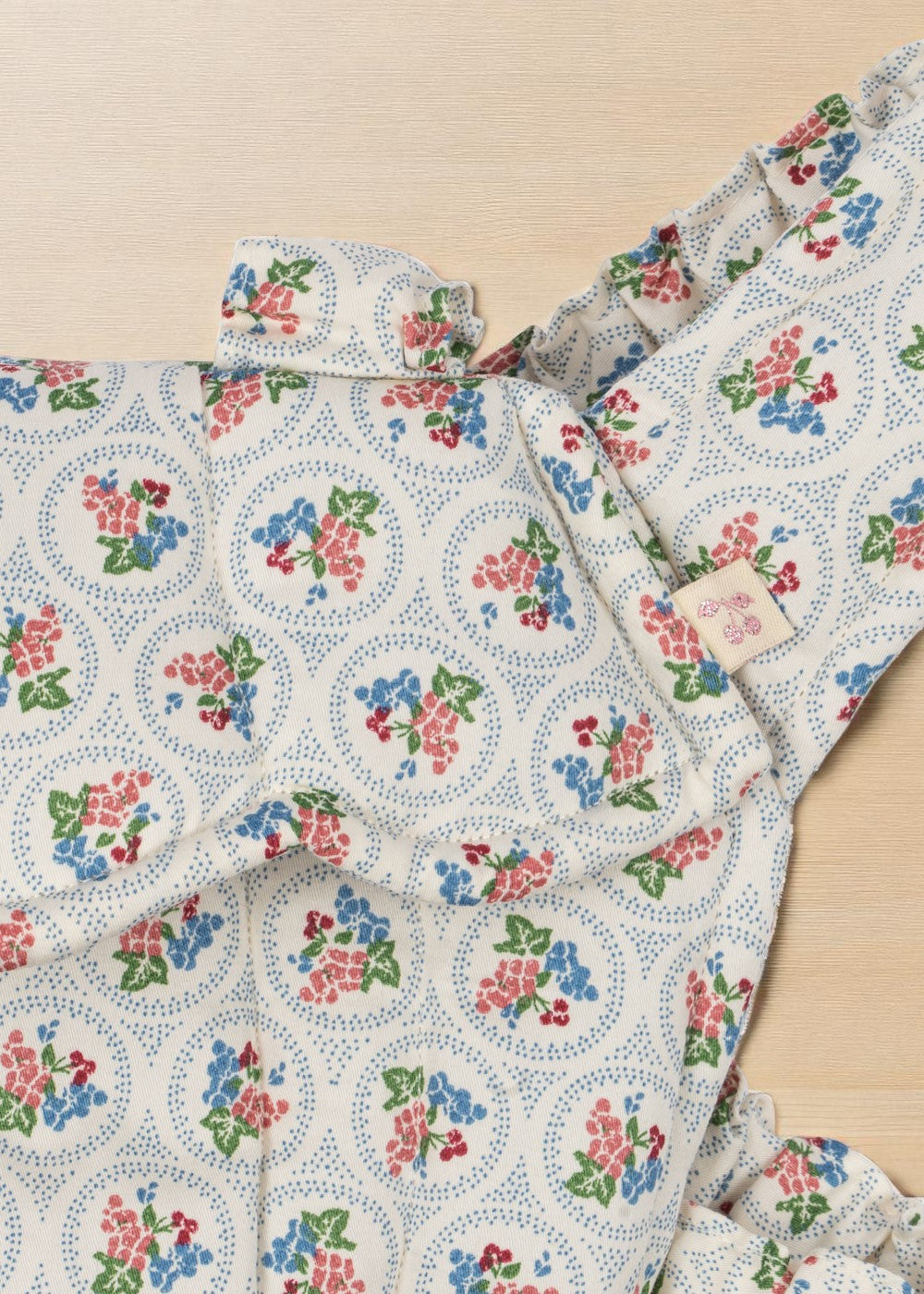 Close-up of Verona Blues print showing cornflower blue flowers, coral blooms, cherries and dotted circle details