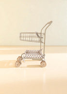 Full view of steel frame doll shopping cart in Verona Blues print with swivel wheels and basket