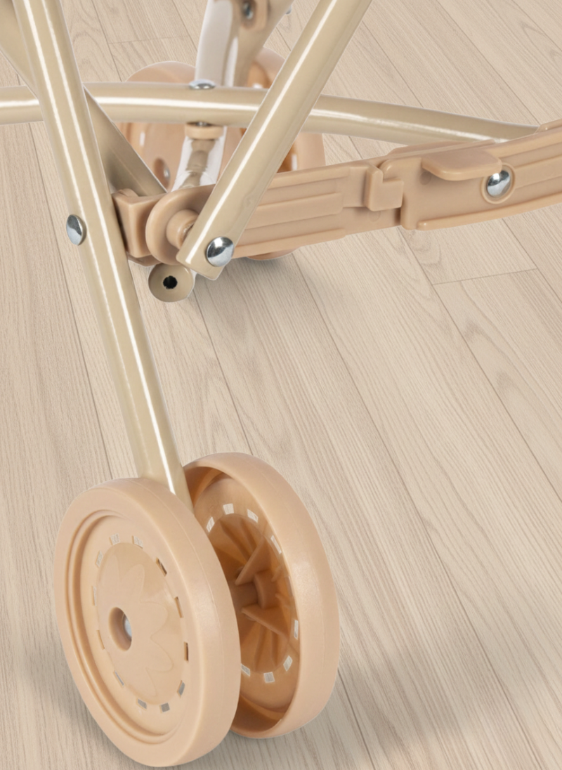 Close-up of a beige dolly with wheels on a wooden floor