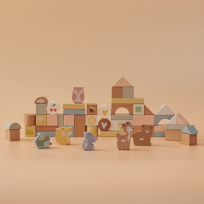 Wooden blocks with animal designs on a beige background
