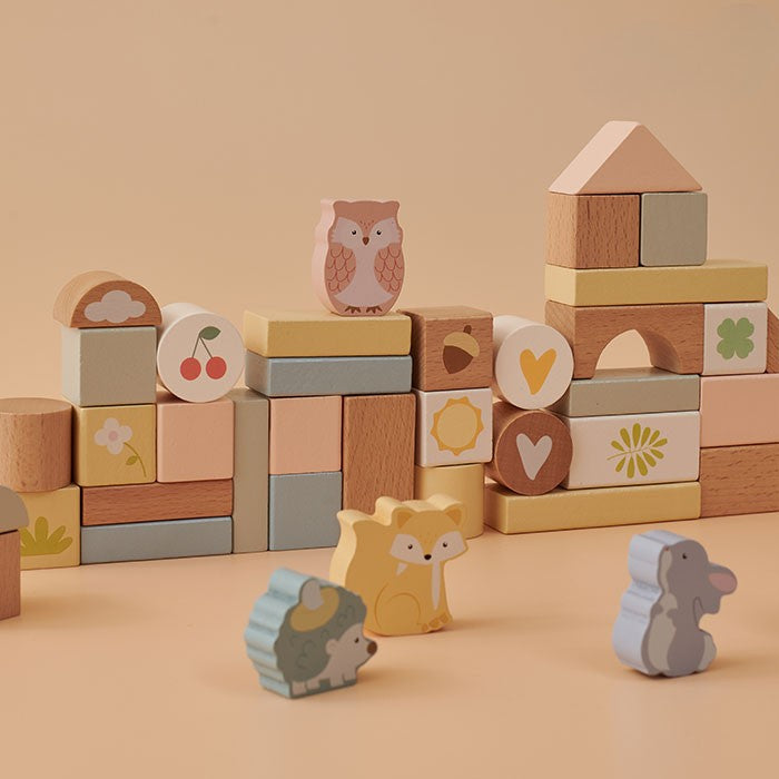 Wooden blocks with animal designs on a beige background