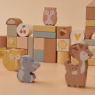 Assorted illustrated accent blocks showing heart, cherry, clover, sun, and cloud printed designs in soft pastel tones