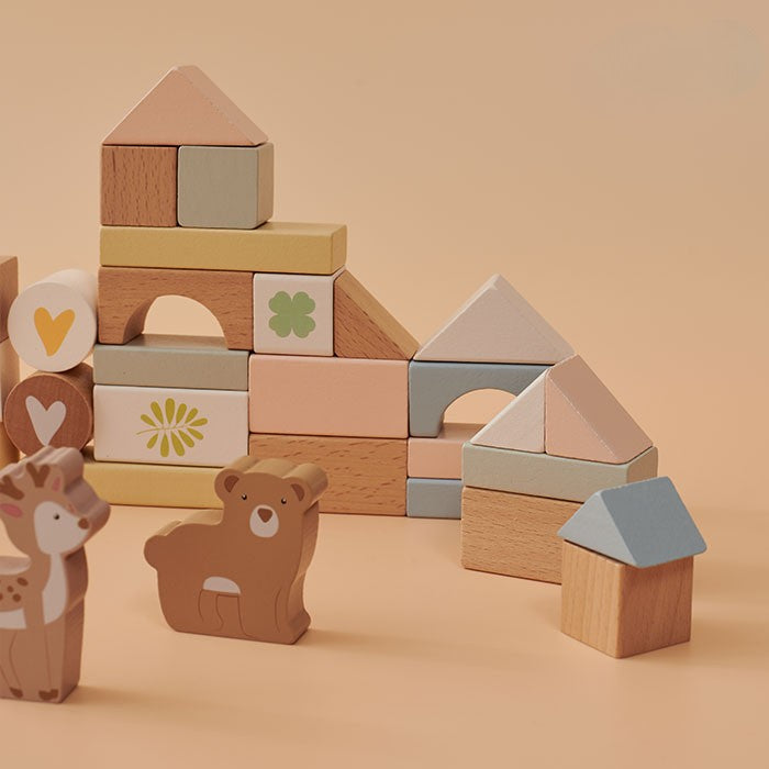 Wooden blocks and animal figures on a beige background
