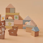 Wooden blocks and animal figures on a beige background