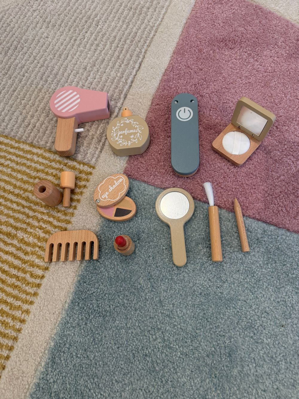 Set of wooden makeup toys on a textured surface