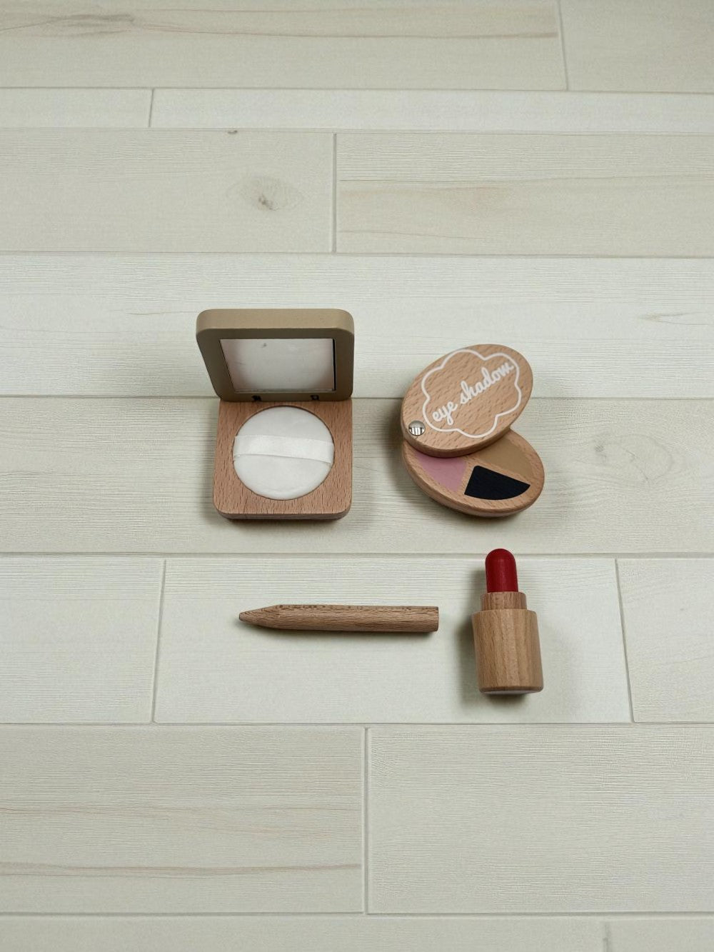 Compact, eye shadow, eyeliner and lipstick