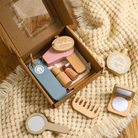Set of wooden makeup toys with a mirror and various items on a textured surface