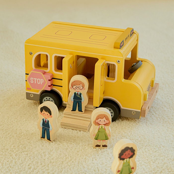 Complete 7-piece wooden school bus set showing bus, driver, four student figures, and wooden step piece