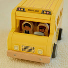 Wooden school bus with removable roof lifted off to reveal interior seats and chalkboard on reverse side