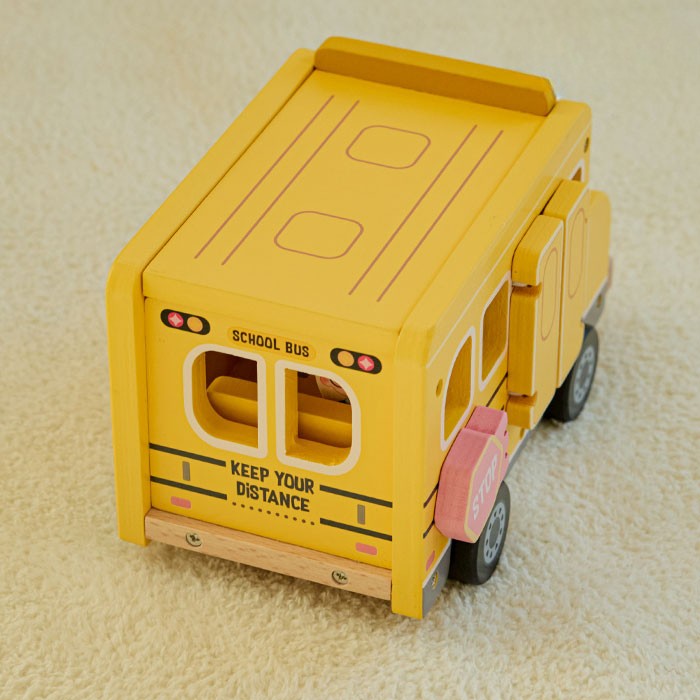Four-step play sequence showing bus driving, roof opening, chalkboard flipping, and classroom pretend play scene