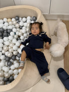 Child lying on the ball pit