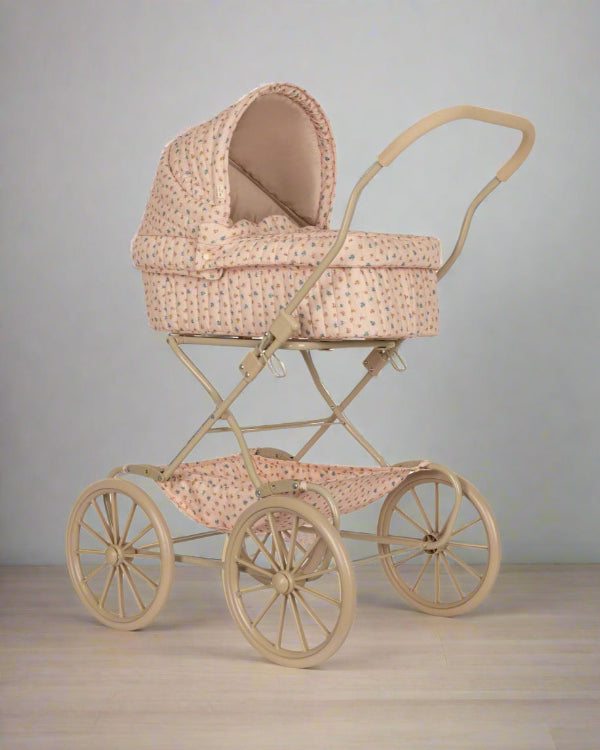Bloomie blush vintage doll pram with soft pink quilted fabric and delicate scattered floral pattern on four large wheels