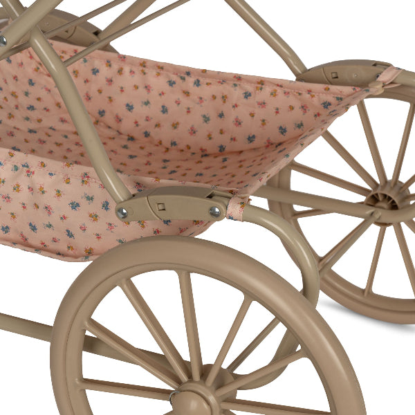 Vintage-style romantic pram with delicate scallop edges and soft-grip handles perfect for tender doll adventures