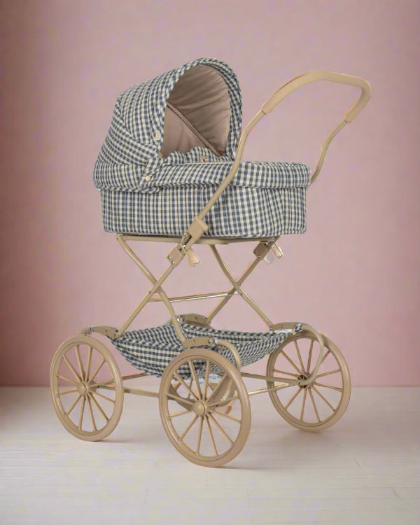 Captains blue check vintage doll pram with navy and white gingham quilted fabric on four large wheels