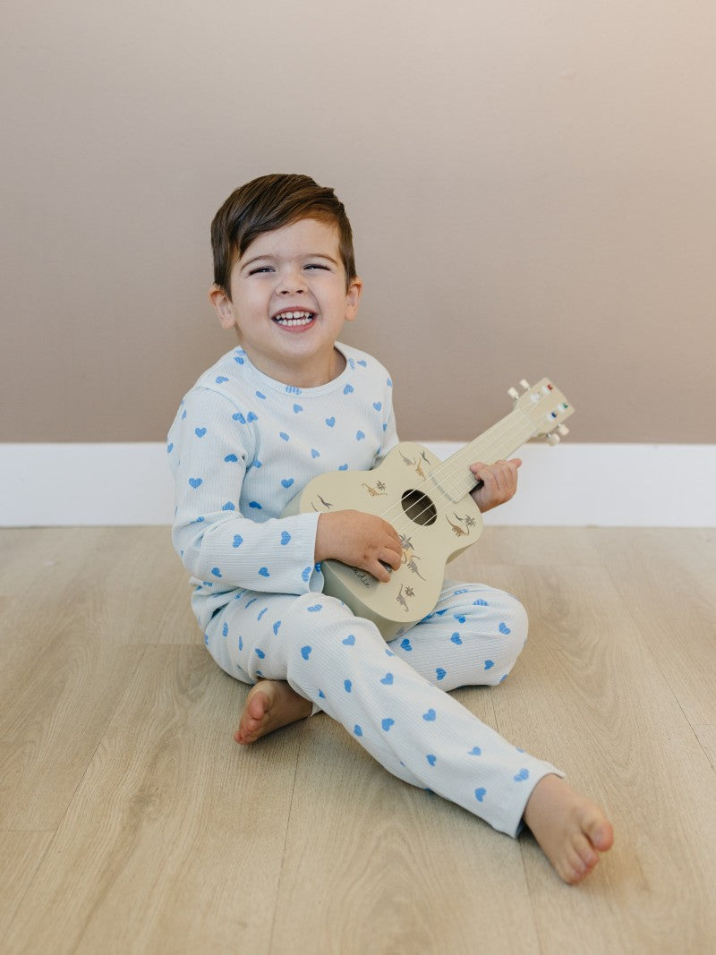 Toddler in blush pink heart print comfort wear showing stretchy movement and fit