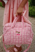Bubblegum check pattern doll bag with coordinated hardware perfect for nurturing play