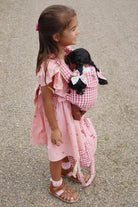 Pink checkered doll carrier with machine washable fabric ideal for daily adventures