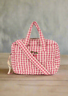 Pink gingham baby doll diaper bag with dual handles and shoulder strap in bubblegum check pattern