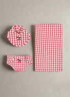 Bubblegum check doll nursery set with gingham bib, diaper, and muslin cloth featuring cherry embroidery