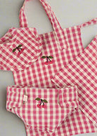 Sweet checkered doll nursery essentials including bib with cherry detail and velcro diaper