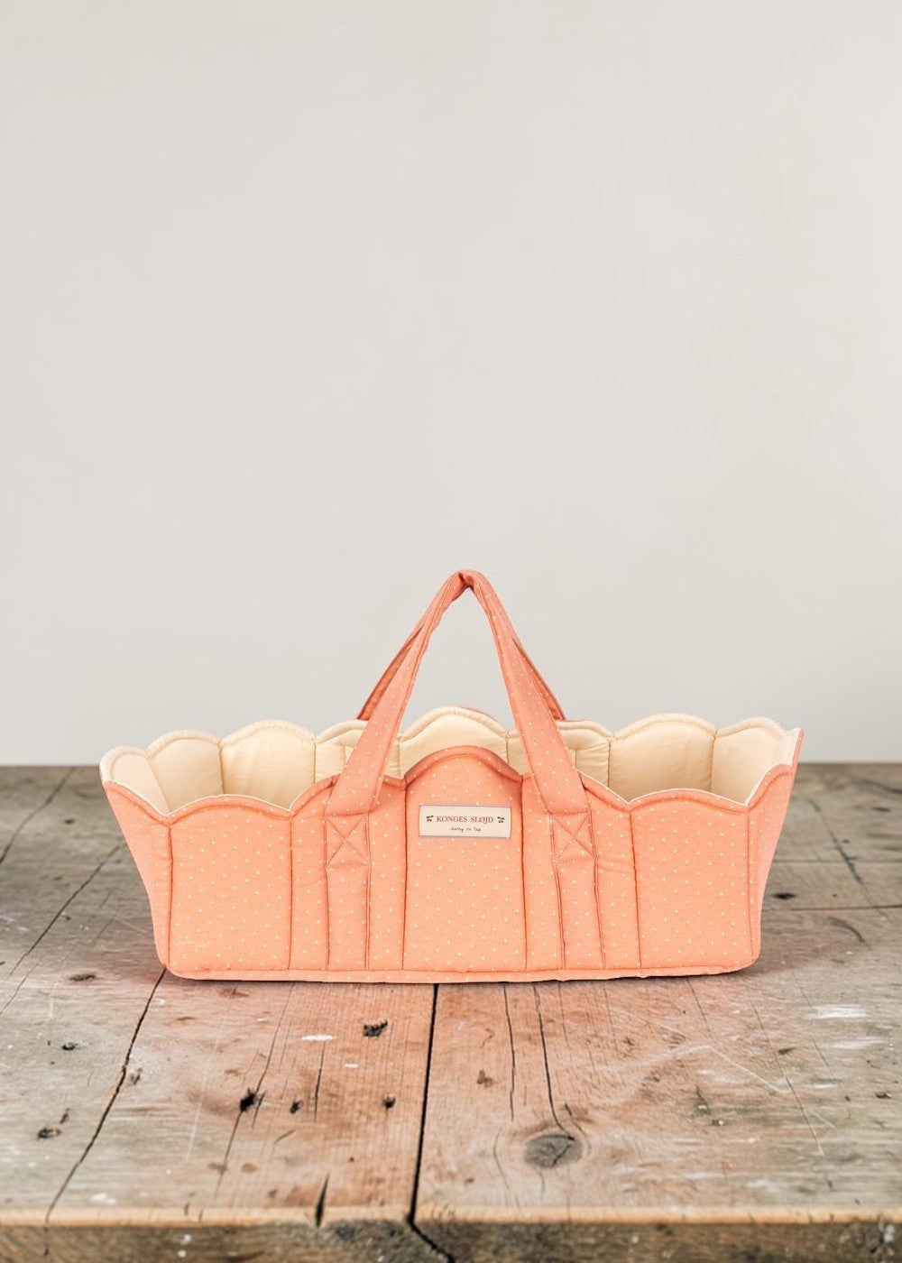 Playroom Collective Konges Sloejd quilted coral doll bassinet with white dots and scalloped cream lining