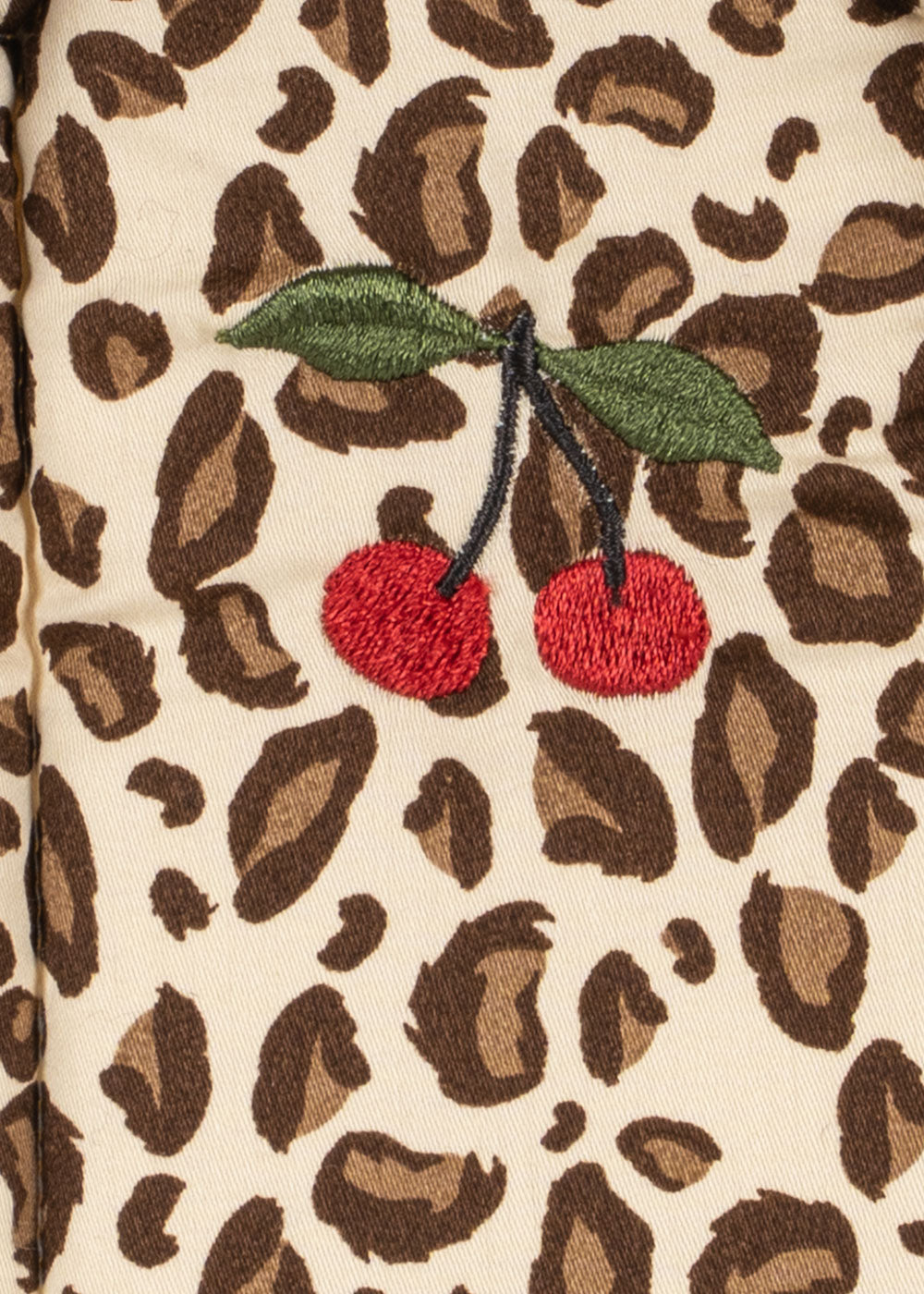 Leopard print fabric with embroidered cherries on a beige background